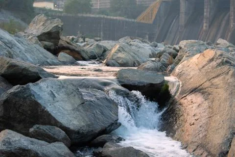 Water stream flowing between the rocks in maithon dam Stock Photos
