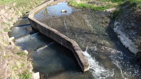 Water stream flowing into the river Stock Footage 131010762