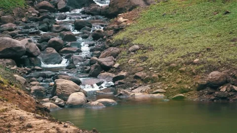 Water stream flowing through rocks on hillside Stock Footage 321002167