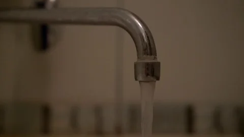 Water stream flows from old metal rusty faucet close view Stock Footage 114797587