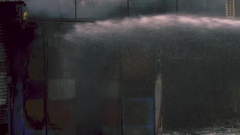 Water stream hitting a smoky structural fire during emergency Vídeos de archivo 327692830