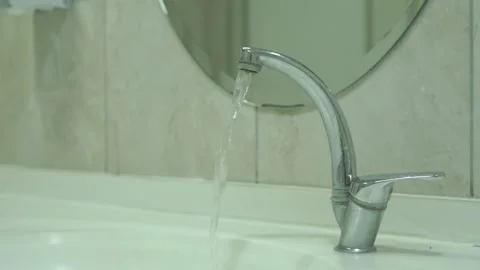Water-stream-leaking-faucet-bathroom-sink-close-up Stock Footage 344801217