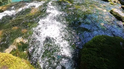 Water stream of a mountain river flows fast. Clear water in a stream Video stock 104535742