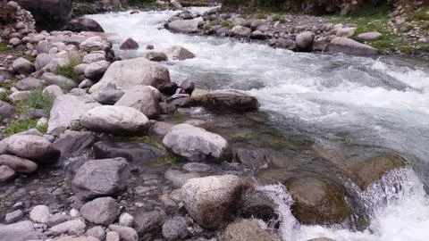 A water stream passing through rocks in Ghizer Valley of Pakistan Stock Photos