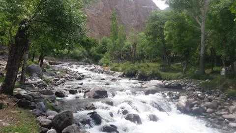 A water stream passing through rocks in Punial Valley Stock Photos