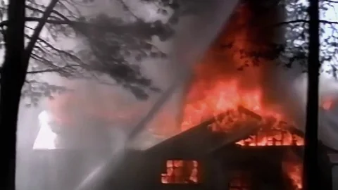 Water stream protects trees during house fire (MOS) Stock Footage 79978452