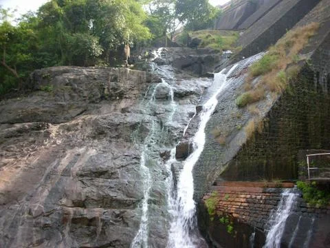 Water stream on the side of a bridge during rainy season Stock Photos