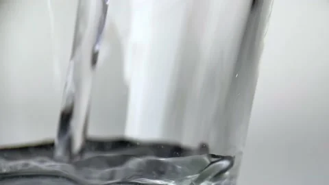 Water stream in slow motion falls on smooth clean surface, creating air bubbles Stock Footage 234454367
