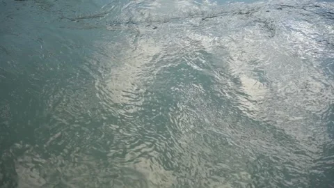 Water stream with swirl and cloud reflection Stock Footage 240818180