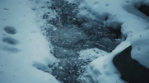 Water stream underneath the frozen river... | Stock Video | Pond5