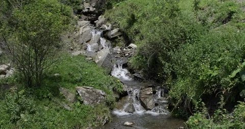 Water streaming along cascade down a Balkan mountain, Bulgaria 4K Stock Footage 94082535