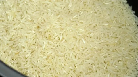 Water streaming down on raw white rice ready to be cooked, includes sound Video stock 63108300
