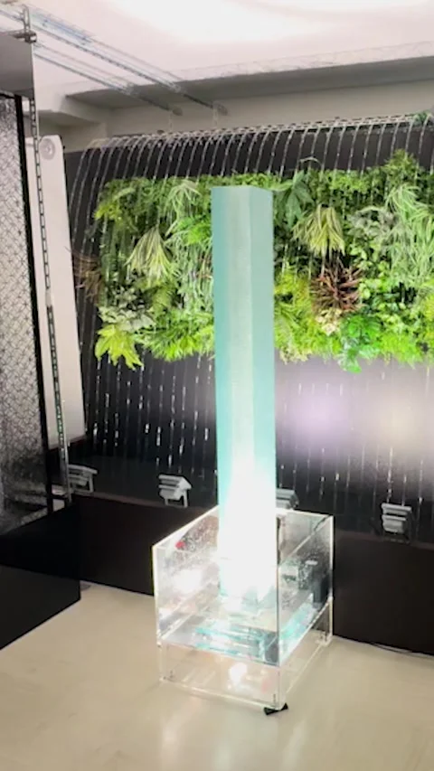 Water streaming down on semi-transparent acrylic square pillar wall peacefully Stock Footage 317476321