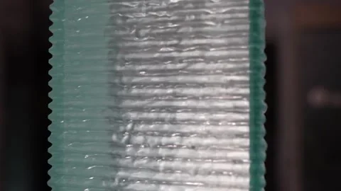 Water streaming down on semi-transparent acrylic square pillar wall peacefully Stock Footage 317476926