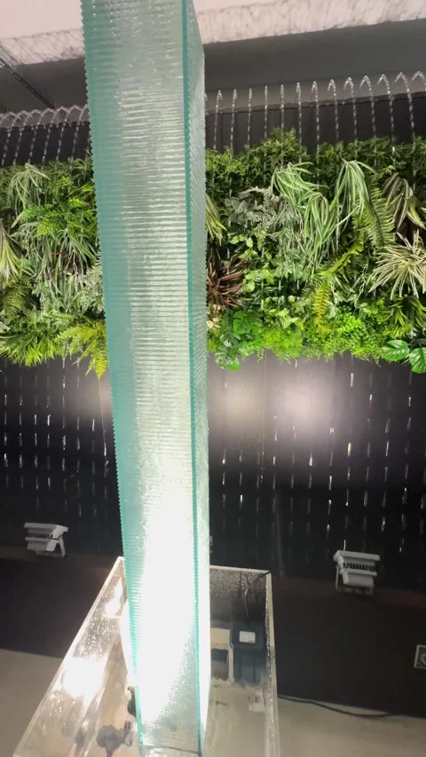 Water streaming down on semi-transparent acrylic square pillar wall peacefully Stock Footage 317476931