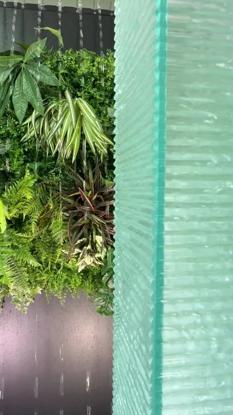 Water streaming down on semi-transparent acrylic square pillar wall peacefully Stock Footage 317476939