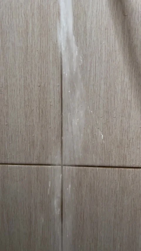 Water Streaming Down From Shower Head Against Modern Bathroom Tile Wall Stock Footage 340989850