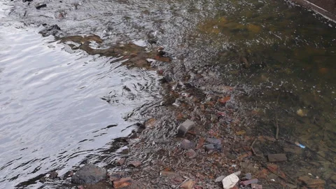 Water Streaming Over Rocks And Rubbish Stock-Footage 149012367
