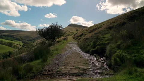 Water streaming over a walking trail path in the English hills Stock Footage 318254699