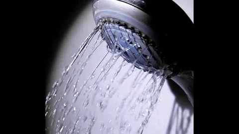 Water Streaming From Shower Head in Dramatic Lighting Stock Footage 325224035