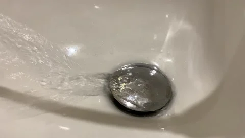 Water streaming in sink. water stream going down the drain. bath Stock Footage 201676729