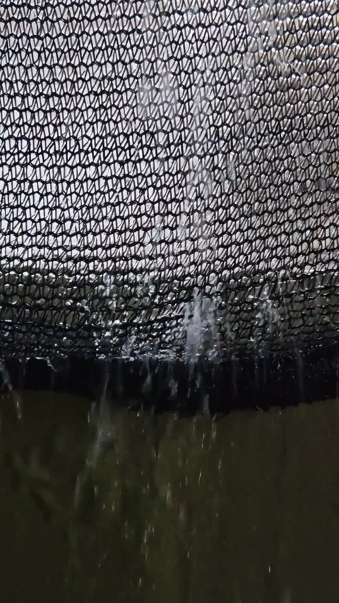 Water Streaming Through Protective Mesh Netting in Rain Video stock 323697482