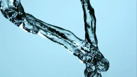 Water streams collide and splash against blue. Stock Footage 326629528