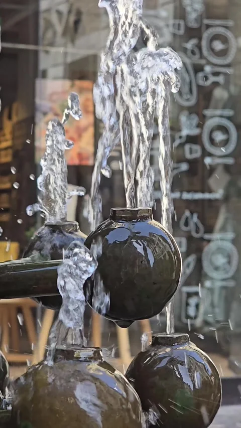 Water streams splashing from round elements of a decorative fountain Video stock 341902907