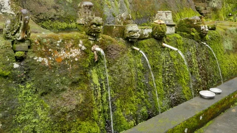 Water streams stone decorations covered with green moss in a sacred place in Stock Footage 184506091