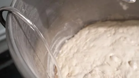 Water supply to the dough starter container in the dough mixer in the bakery. An Video stock 295874899