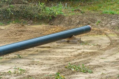 A water supply pipe with insulation for supplying hot water. A dug trench f.. Stock Photos