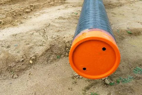 A water supply pipe with insulation for supplying hot water. A dug trench f.. Stock Photos