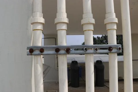 Water supplying pipelines placed vertically in a group with metal bracket Stock Photos