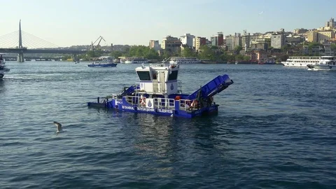 Water surface cleaning boat sails in Halic Bay. Debris and bilge water  Stock Footage 78283975