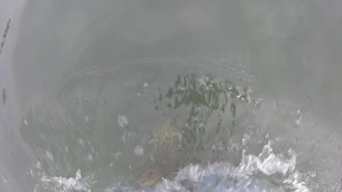 Water surface creating abstract patterns with ripples and splashes. Fluid Stock Footage 343103328