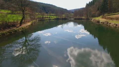 The water surface of the Eutersee is reflecting the clouds Stock Photos