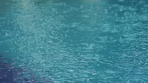 Water surface with falling drops filmed from above in slow motion. Close-up o Stock Footage 169321134