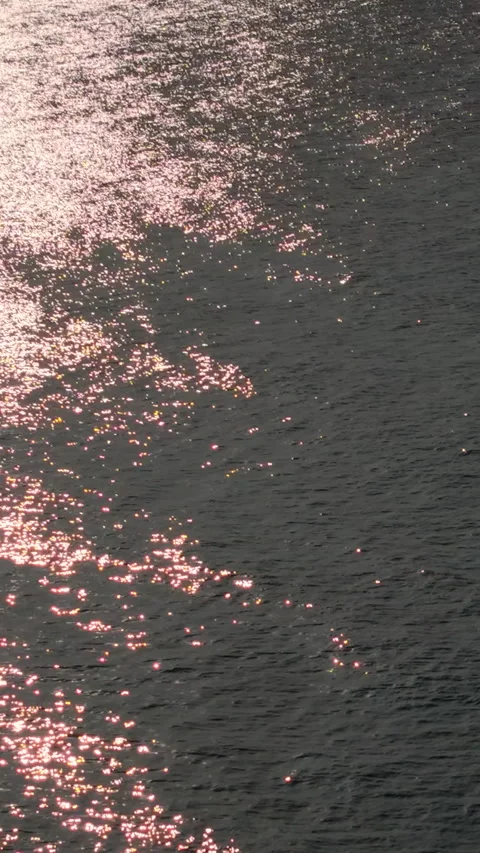 Water surface with golden reflections on beach background Stock-Footage 318115941