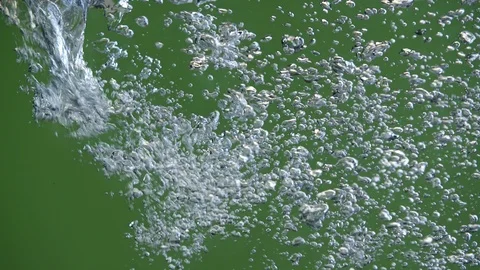 Water surface isolated. Pouring water air bubbles on green background Stock Footage 89941874