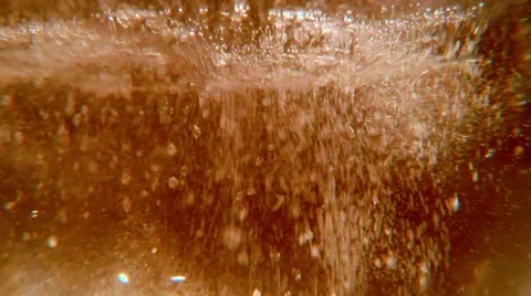 Water Surface in a Light Orange Light Boiling With Plurality of Bubbles Stock Footage 61315927