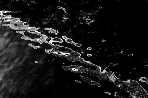 Water surface making multiple water circles against blue background beauty Stock Photos