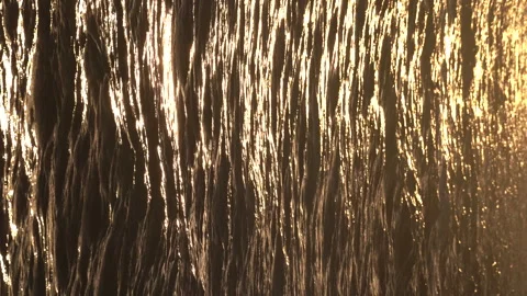 Water surface of ocean with small waves and ripples at sunset in the evening. Video stock 240202218