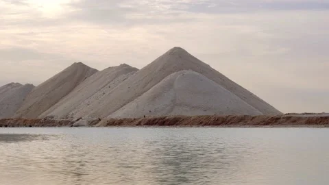 The Water Surface Of A Pond And Piles Of Mined Salt Stock Footage 234459015