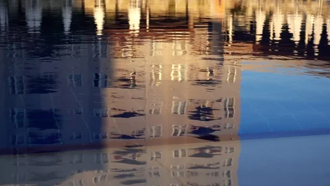 Water surface of the pool. Light ripples and reflection of sun loungers and u Stock Footage 93434445