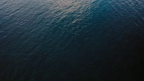 Water surface reflecting light in an open sea Stock Footage 325198357