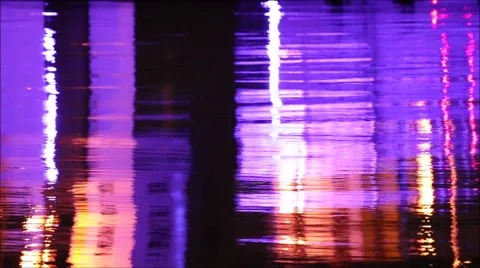 Water surface reflecting multicolored changing lights in abstract pattern Stock Footage 41196930