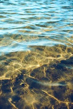 Water surface reflections at the beach Stock Photos