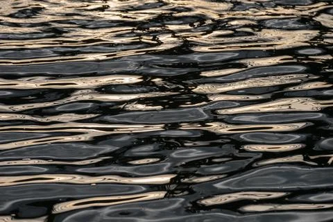 Water surface ripple with reflection and golden shining Stock Photos