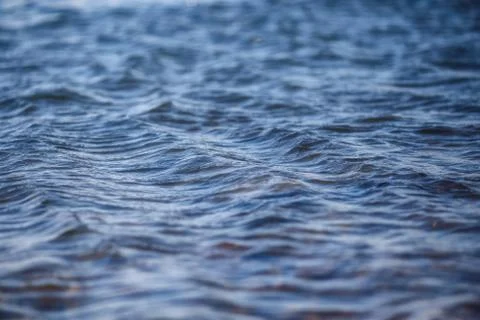 Water surface with ripples and reflections texture background Stock Photos