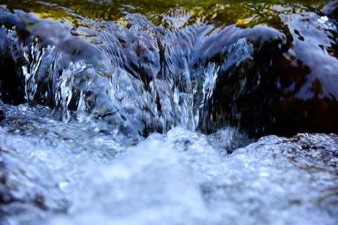 Water surface with ripples and sunrays reflections Stock Photos